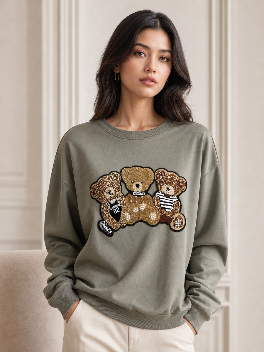 Panda Print Sweatshirt in olive green with gold sequin panda bear patch; relaxed fit for casual everyday wear.