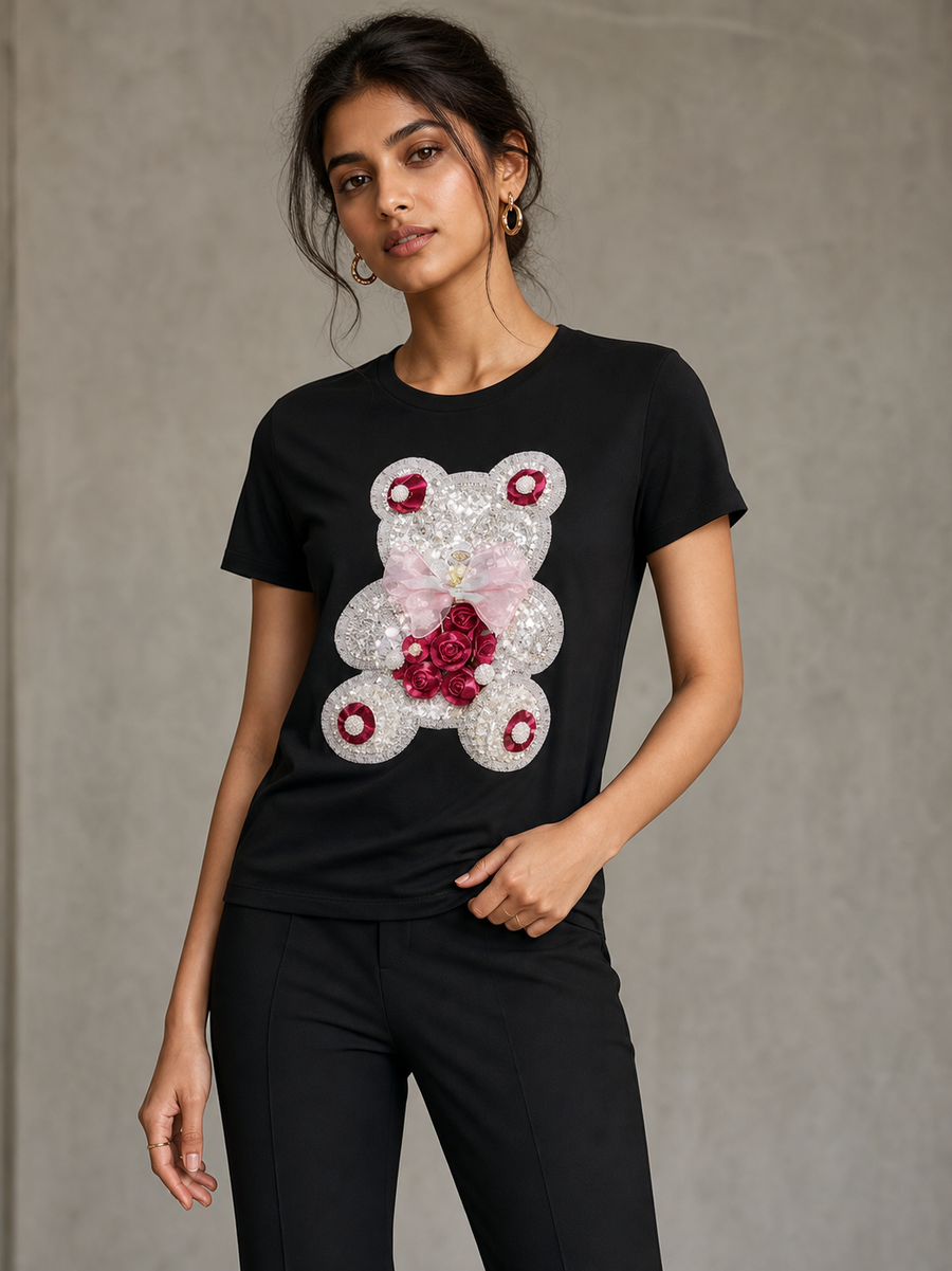 Print M O Sequins T-Shirt, black top with a sequined bear graphic and pink bow.