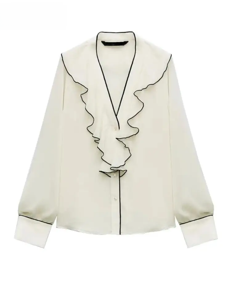Cream blouse with black piping along V-neck and front, cascading ruffles, button-front, and cuffed long sleeves.