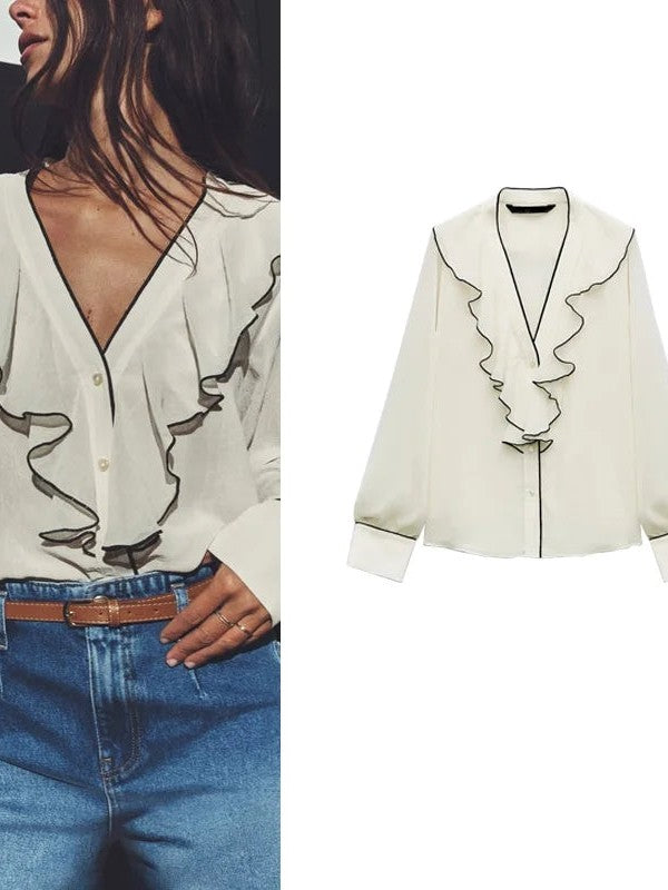 Cream V-neck jacquard blouse with black-piped ruffle trim along the front, long sleeves, button placket.
