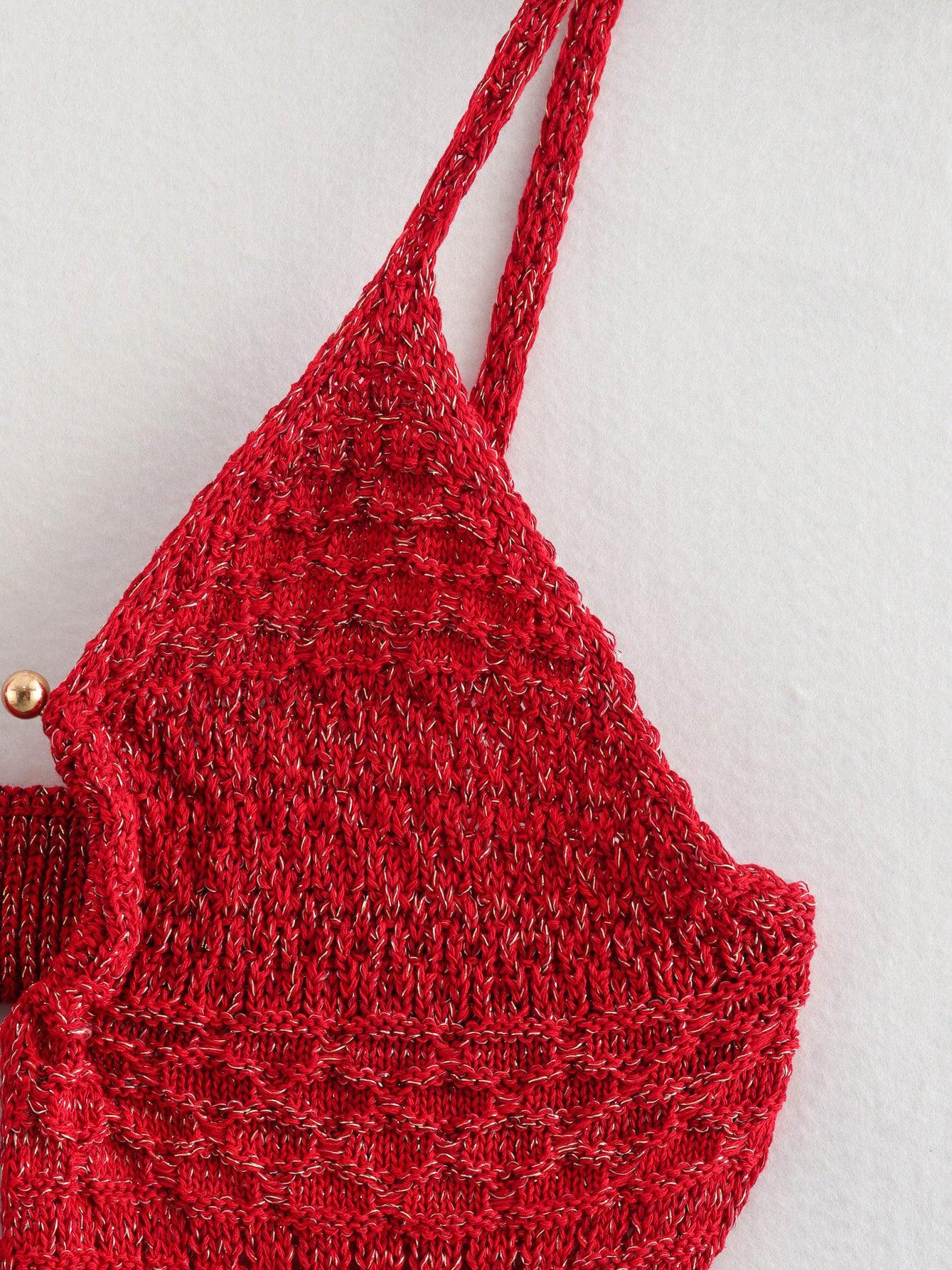 Red knitted tote bag with two long straps and a gold-tone button closure, textured stitch on a light background