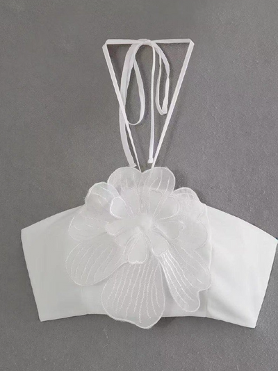 White halter-neck tube top with a large 3D layered flower applique and ribbon ties at the neck.