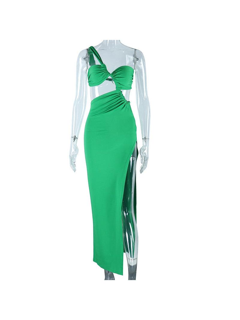 Emerald green one-shoulder bandeau twist maxi dress with left-shoulder strap and side slit on a clear mannequin.