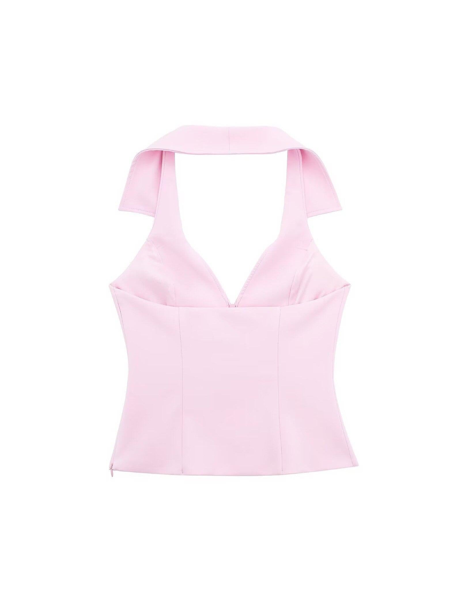 Pink halterneck waistcoat top with wide straps, V-neck and panel seams; part of a pink skort coord set.