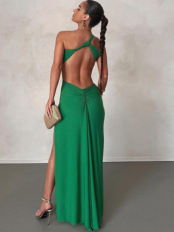 Emerald green bandeau twist one-shoulder backless maxi dress with high slit and back ruched, model with braid and clutch.