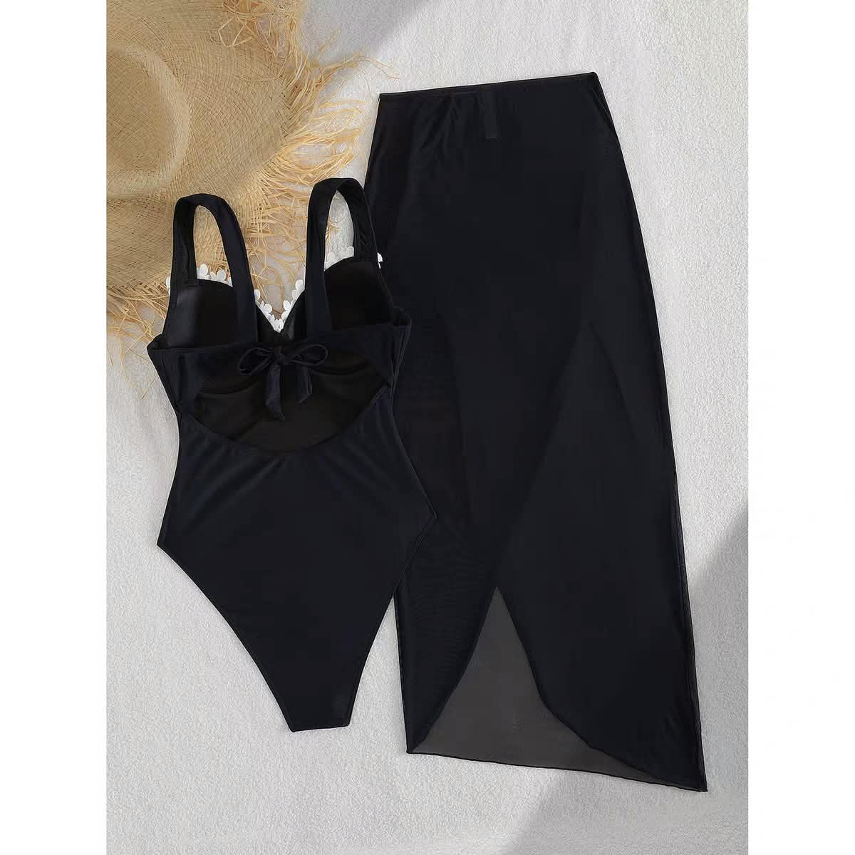EXCLUSIVES Marbella Blossom Swimset: black one-piece swimsuit with bow detail and matching long skirt.