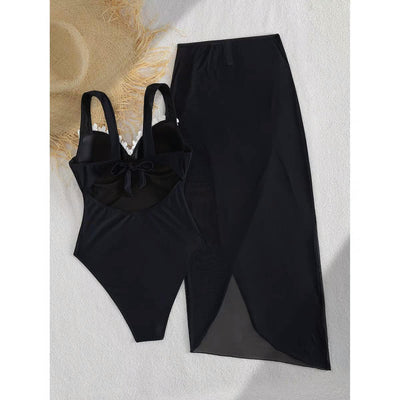 EXCLUSIVES Marbella Blossom Swimset: black one-piece swimsuit with bow detail and matching long skirt.