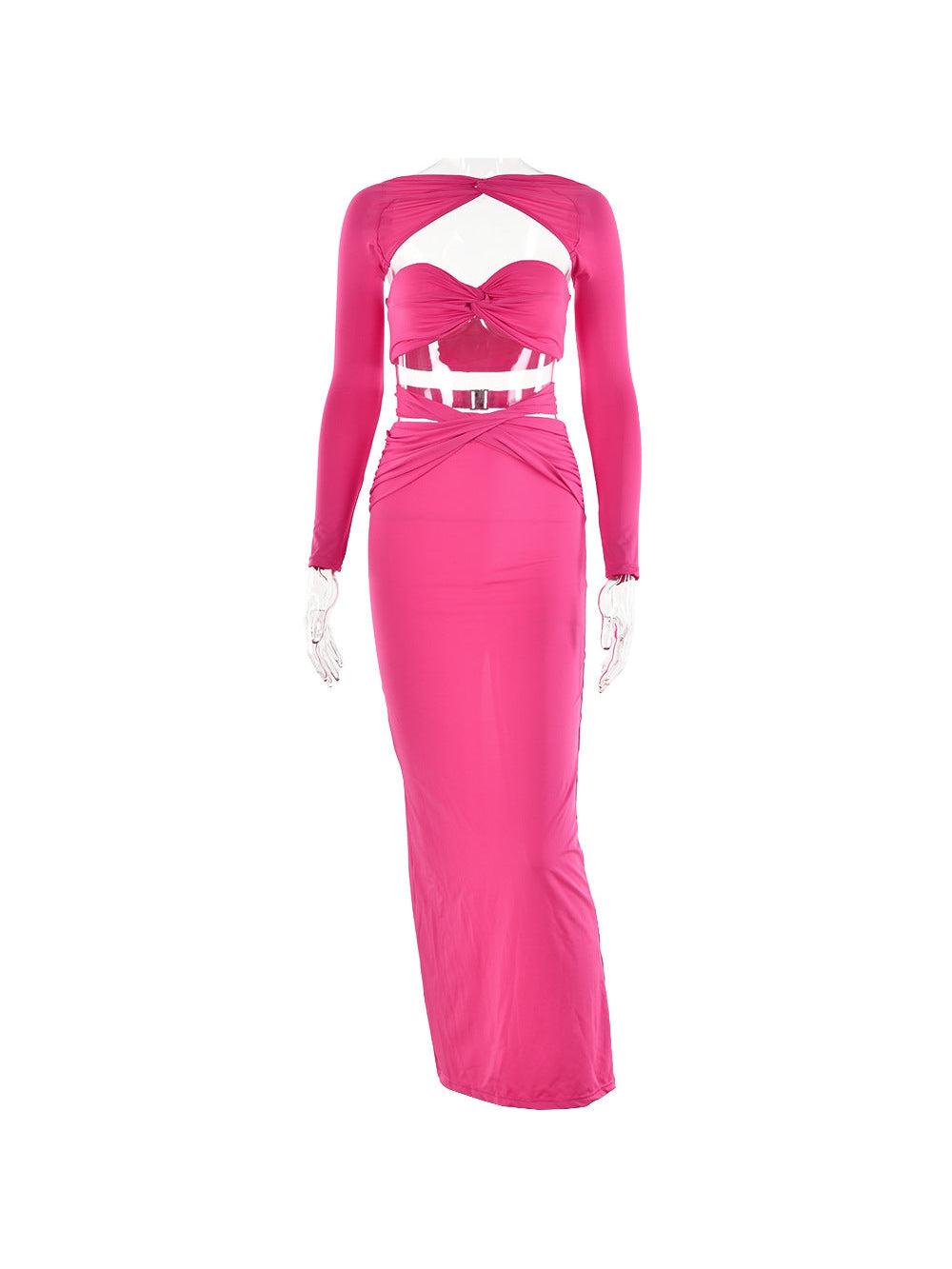 Bright pink satin bandeau top with twist and long sleeves, paired with a high-waisted pink maxi skirt with front knot.