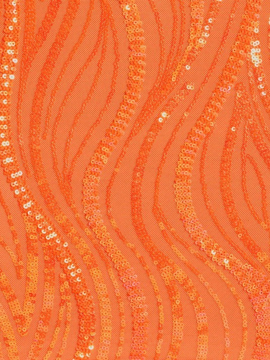 Close-up of bright orange sequined fabric with a wavy striped pattern.