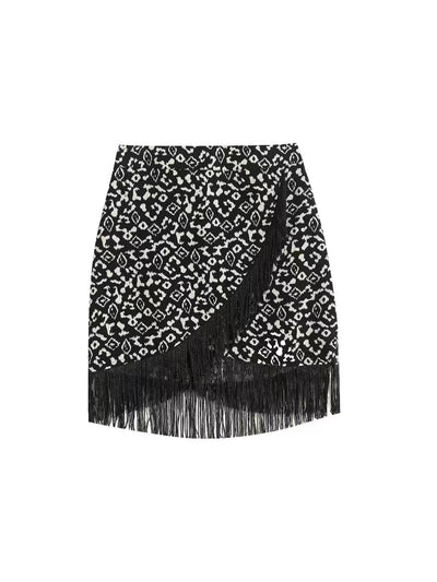 Black and white leopard-print mini skirt with a diagonal wrap panel and long fringe hem.