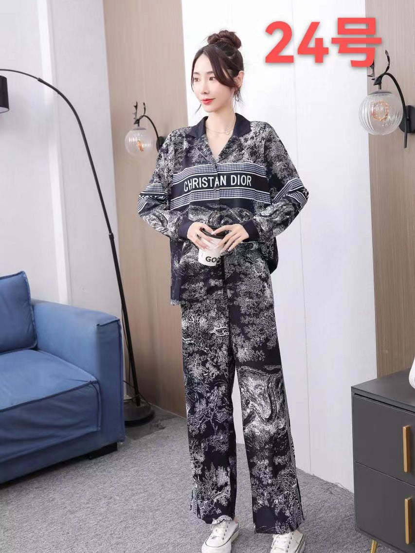 Monochrome paisley-print shirt and matching wide-leg pants coord set with a bold chest stripe reading CHRISTIAN DIOR.