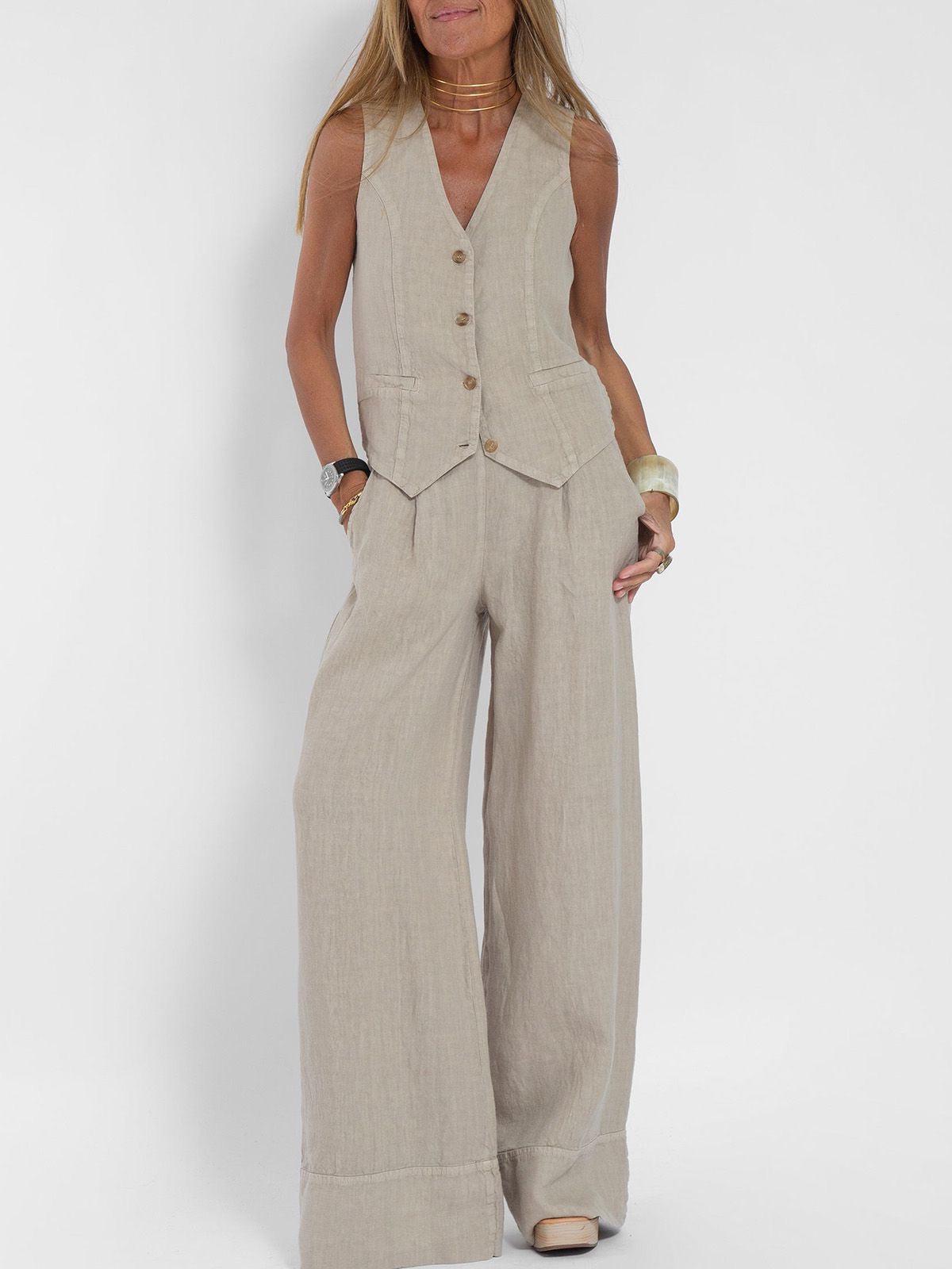 Beige linen waistcoat with V-neck and brown button front, paired with matching wide-leg pants worn by a model.