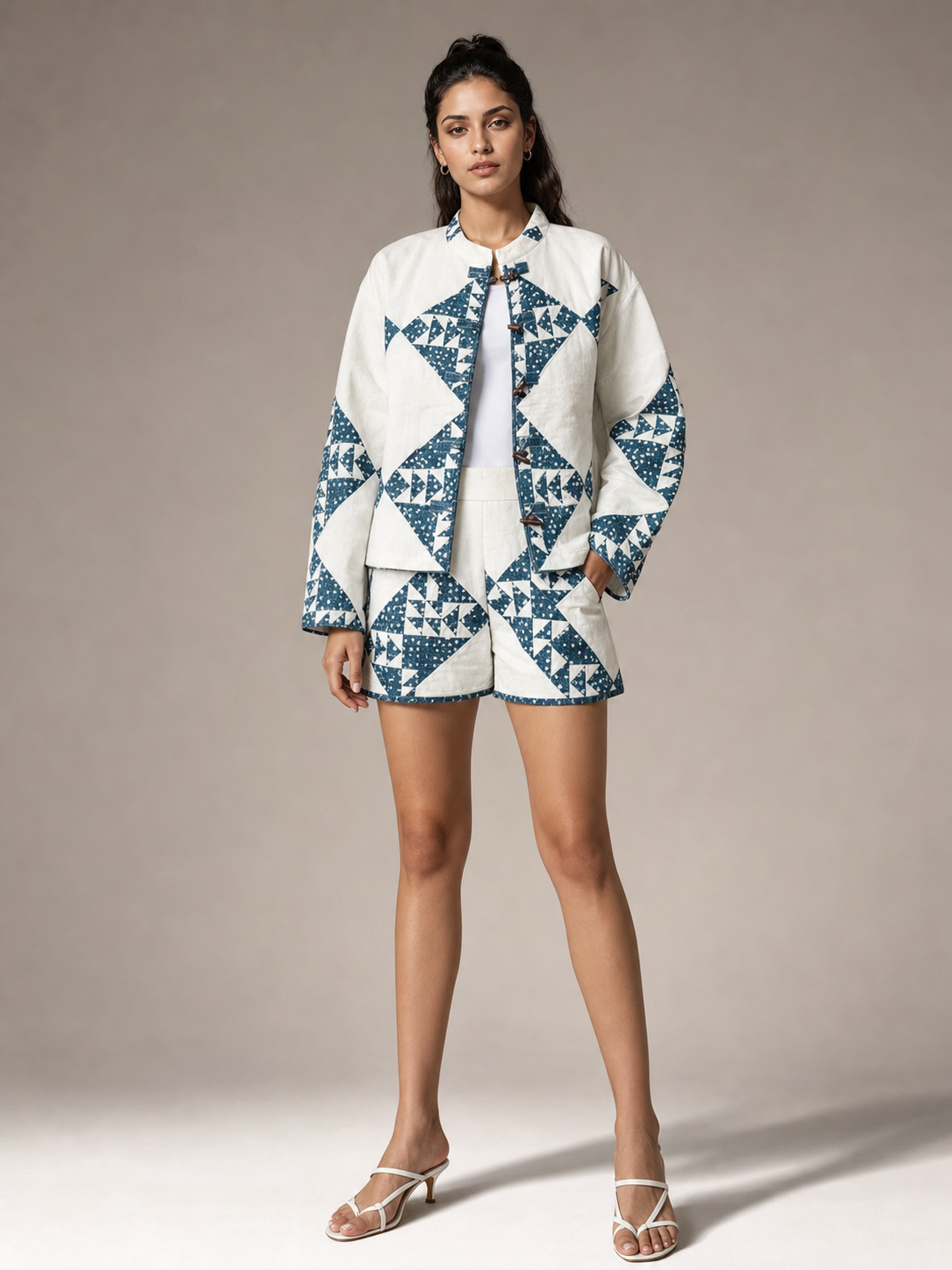 Two-piece coord set Exclusives: loose stand-collar jacket with matching high-waist shorts in white and blue geometry.