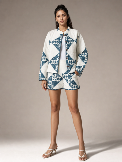 Two-piece coord set Exclusives: loose stand-collar jacket with matching high-waist shorts in white and blue geometry.
