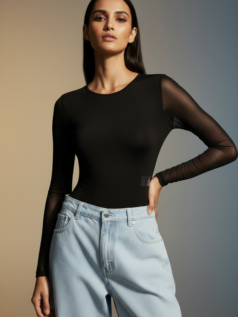 Printed Mesh Tulle Bodysuit on sale by Exclusives, black sheer long-sleeve top with light-wash jeans, two-piece outfit.