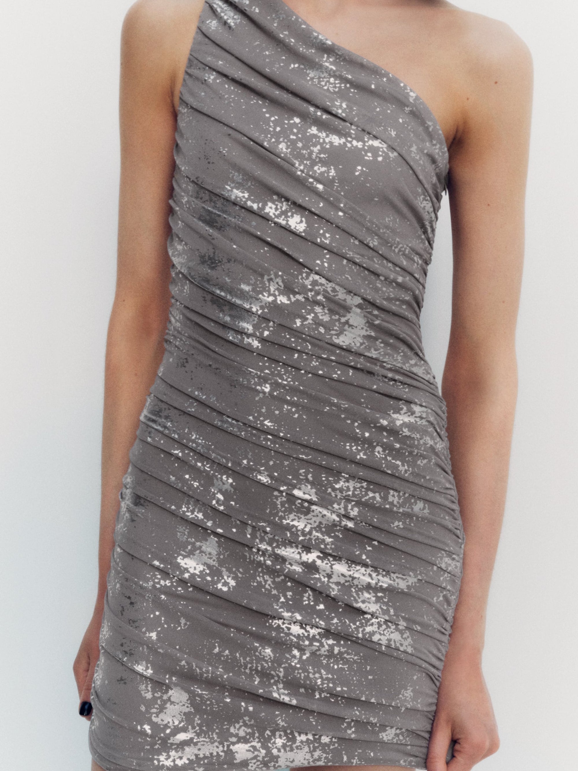 One-shoulder gray mesh tulle dress with draped ruching and silver metallic speckle pattern.