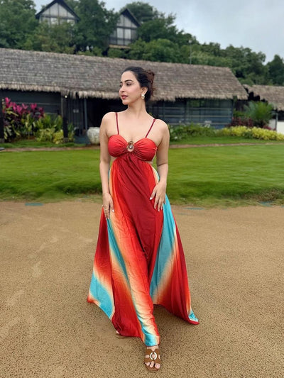 Woman wearing a red-to-blue gradient tie-dye maxi dress with a front ring cutout and thin straps.