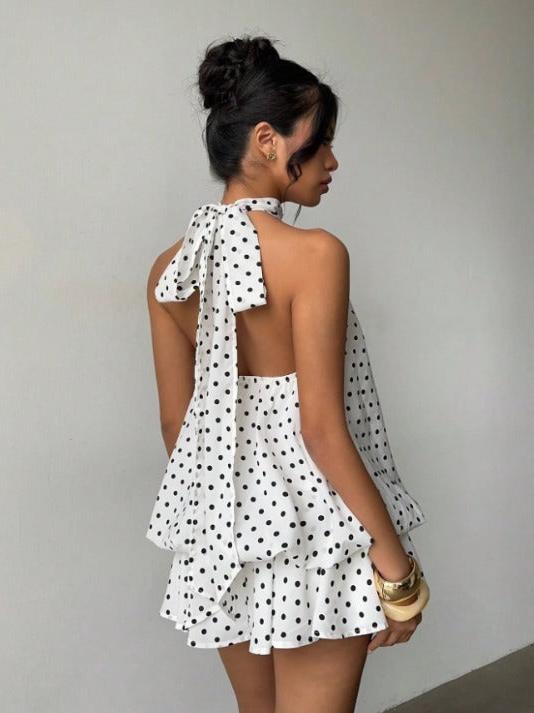 Vintage Charm Backless Polka Dress; white fabric with black polka dots, halter neck tie, layered ruffle skirt