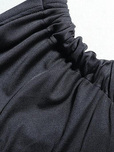 Close-up of black fabric with a ruched, gathered twist at the neckline.