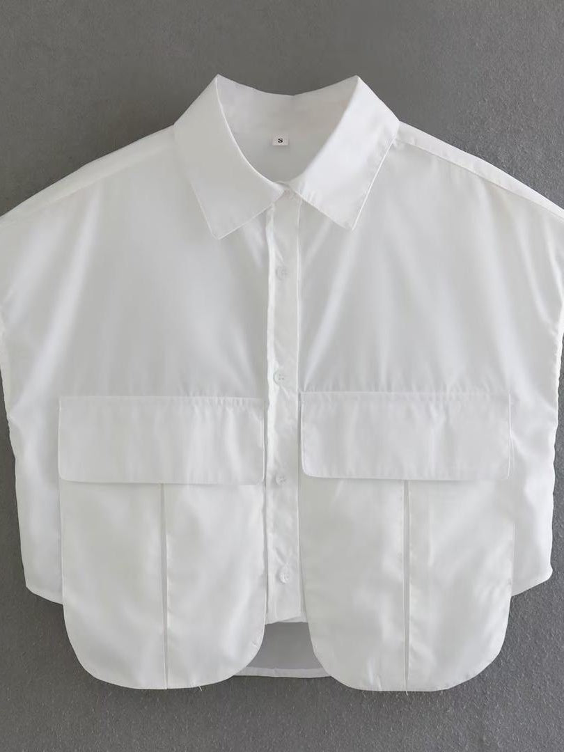 White cotton cropped shirt with a classic collar, front button placket, and two large pocket flaps.