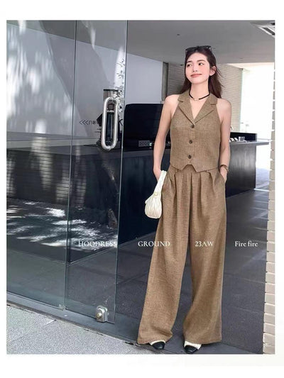 Tan cropped waistcoat with notch lapels and buttons, paired with high-waisted wide-leg pants in linen-like fabric