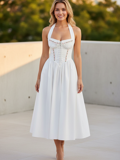 White embroidered corset halter dress with pink floral trim and lace-up bodice, A-line midi skirt.