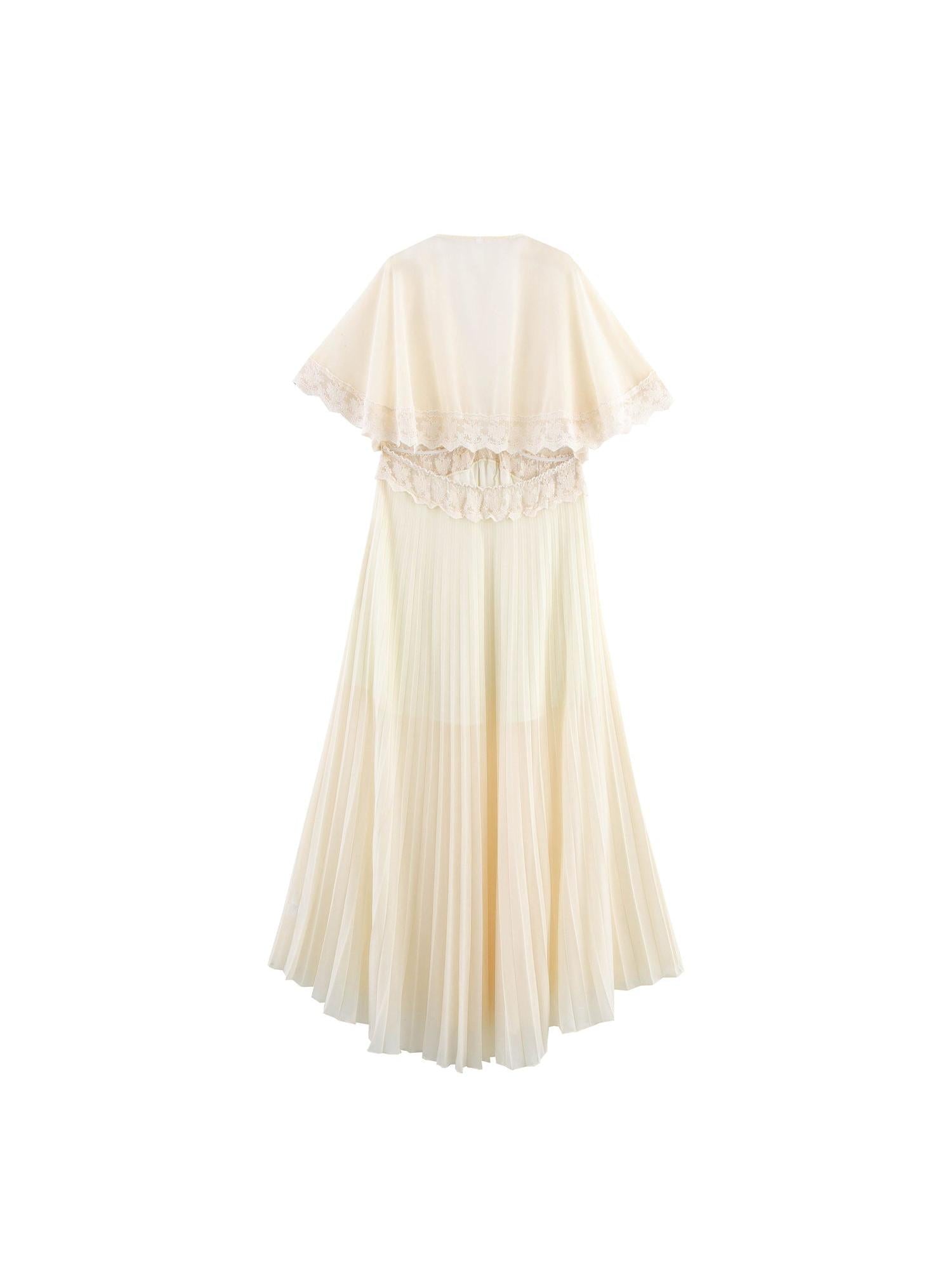 Cream pleated maxi dress with sheer lace-trim cape sleeves, back view.