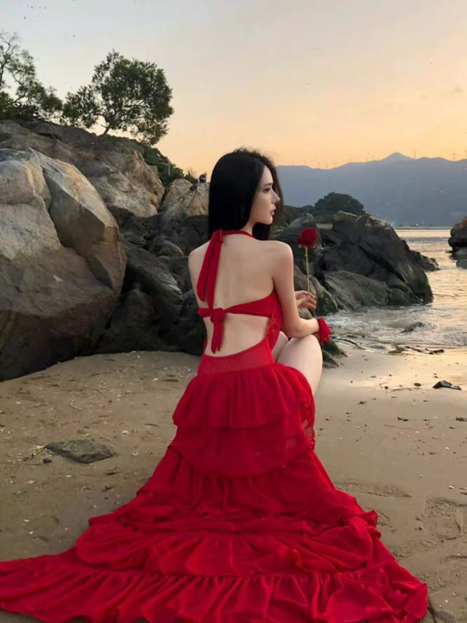 Red Siren Ruffle Swimsuit Set with halter-back ties and tiered ruffle skirt on beach