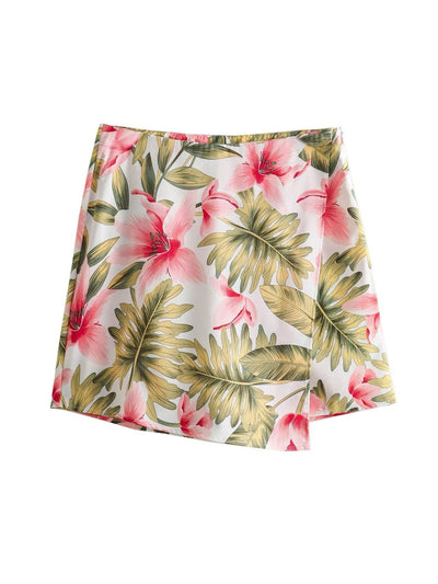 White mini skirt with tropical pink hibiscus flowers and green palm leaves print.