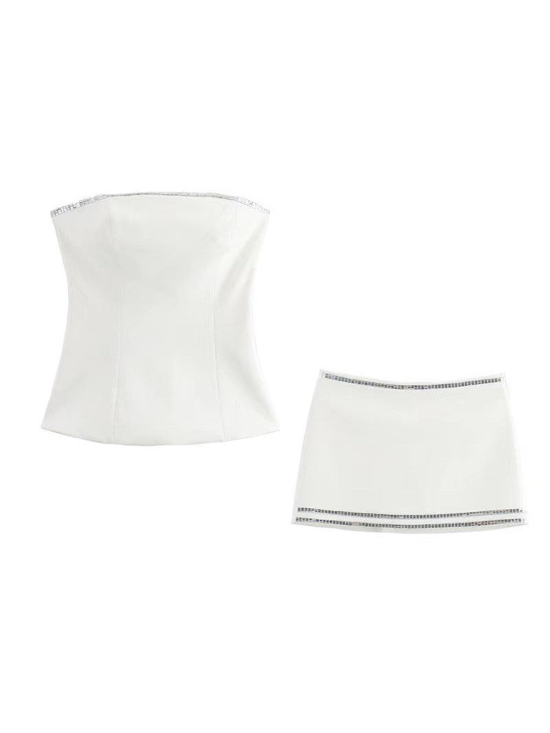 White strapless tube top with seam lines and silver rhinestone trim; matching white mini skort with rhinestone borders.