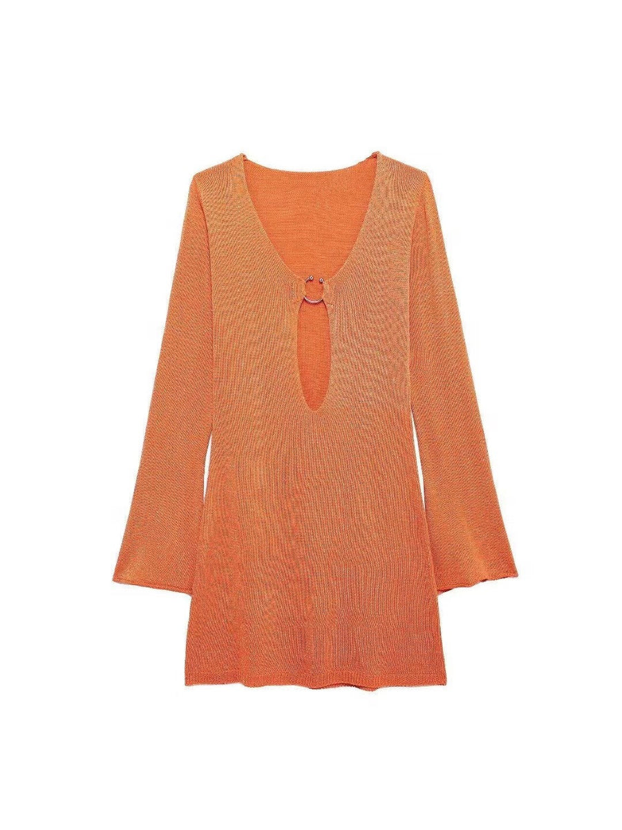 Orange knit mini dress with deep V-neck and oval keyhole cutout linked by a metal ring, long sleeves.