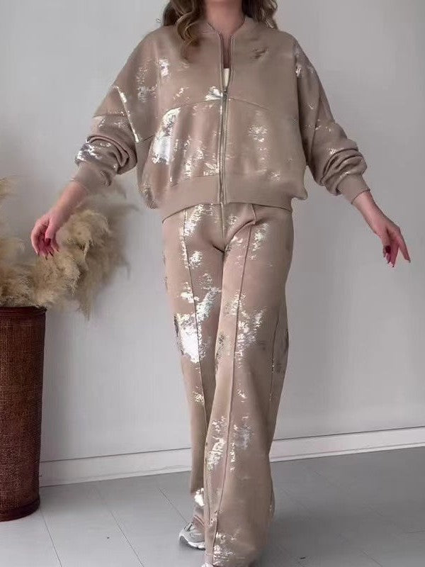 Beige metallic patch long-sleeve zip-up bomber jacket with matching wide-leg pants featuring reflective foil patches.