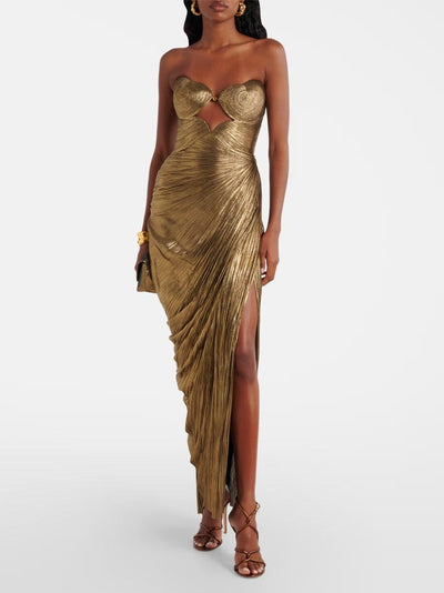 Gold metallic pleated strapless maxi dress with a central cut-out and draped wrap, high slit.