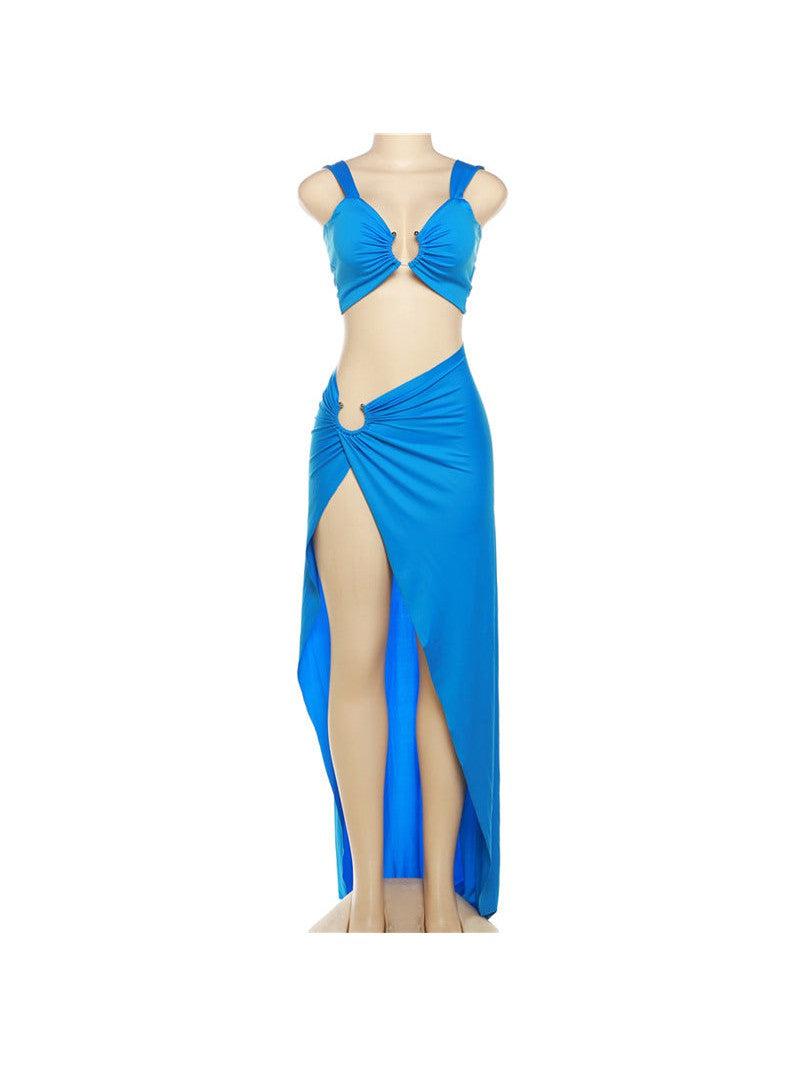 Electric blue two-piece: cutout cropped tank top with center ruching and a high-waisted, front-slit maxi skirt on a mannequin.