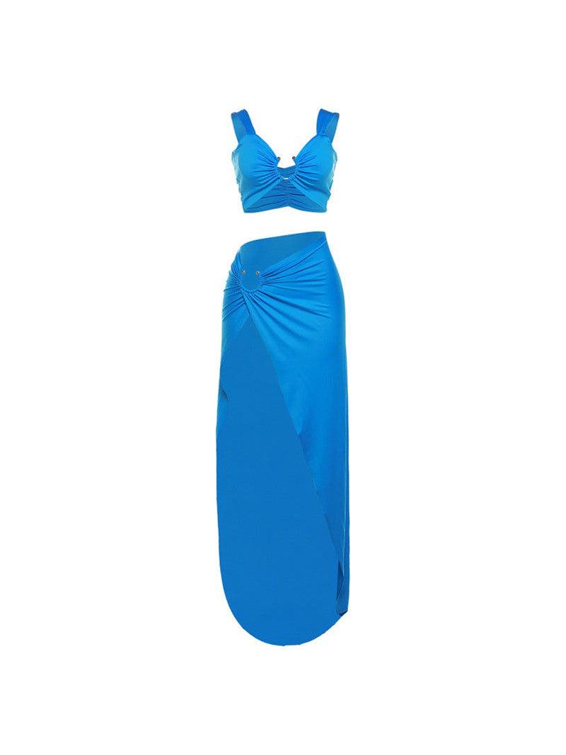 Bright cobalt blue cropped tank top with ruching and knot, paired with high-waist draped maxi skirt with side ruching.
