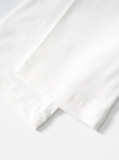 Close-up of white fabric sleeve hem with two parallel rows of stitches and gentle folds.