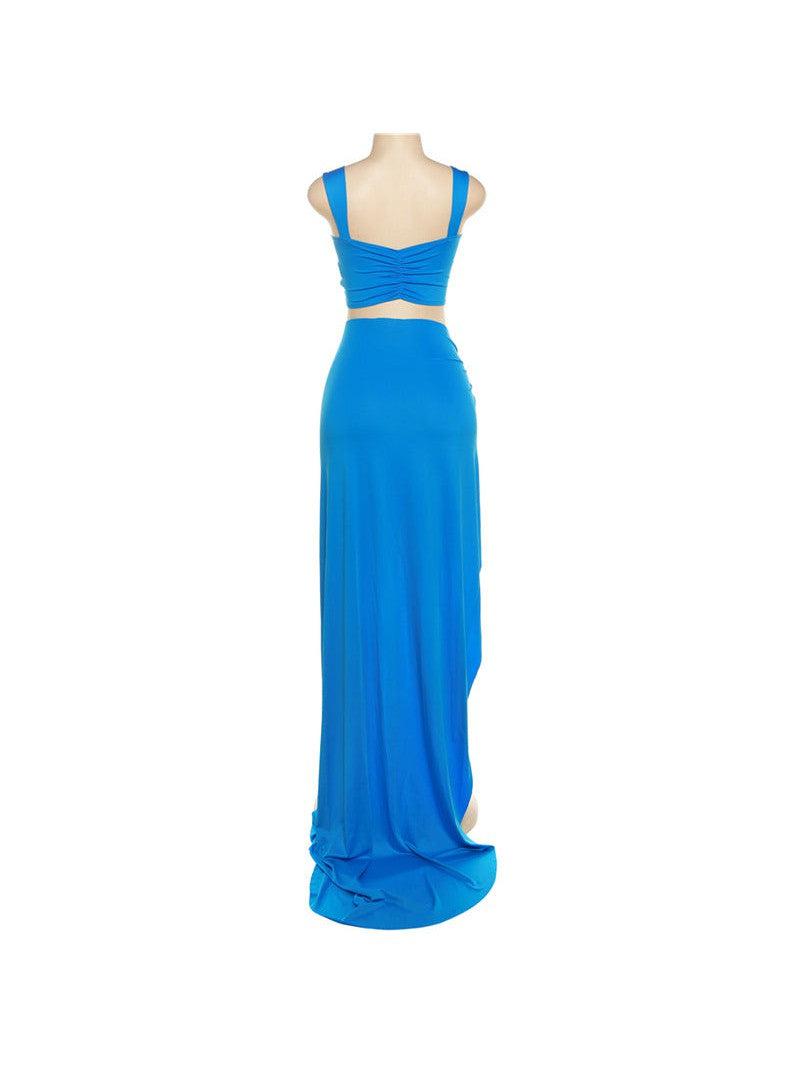 Back view of electric blue cropped tank top with ruched back and wide straps, paired with a high-waisted maxi skirt.