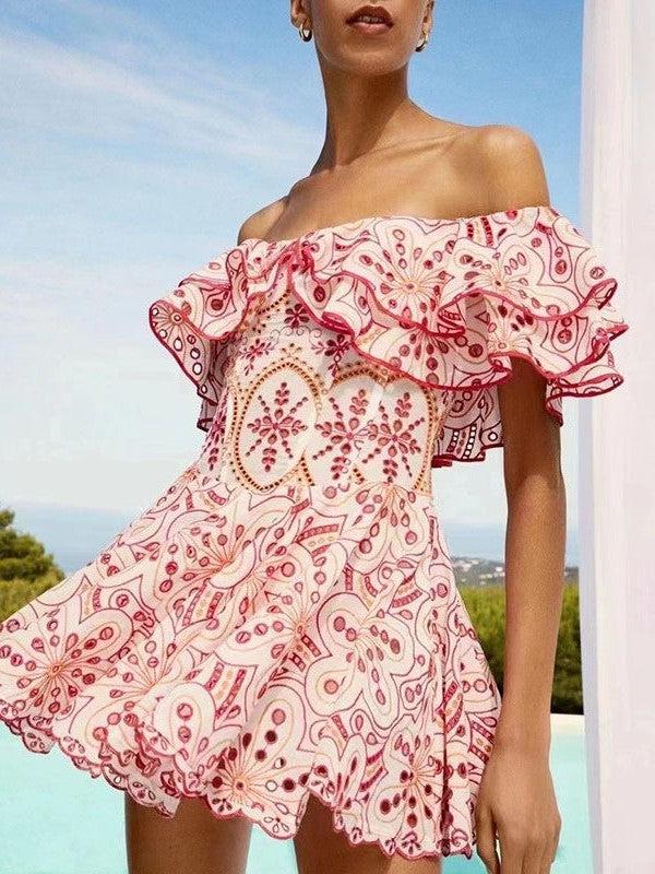 Off-shoulder white cotton dress with pink floral and paisley embroidery, ruffled neckline and scalloped hem by a pool.
