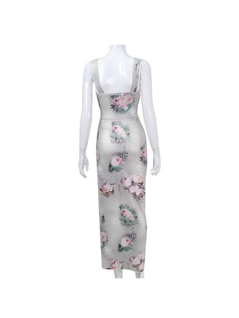 Back view of a pale satin maxi dress with pink rose floral print and wide shoulder straps on a mannequin.