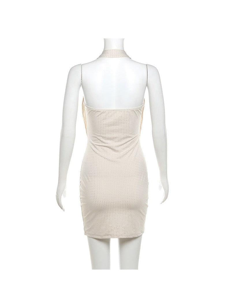 Beige halter-neck, backless, dotted textured slim-fit sheath dress on a mannequin.