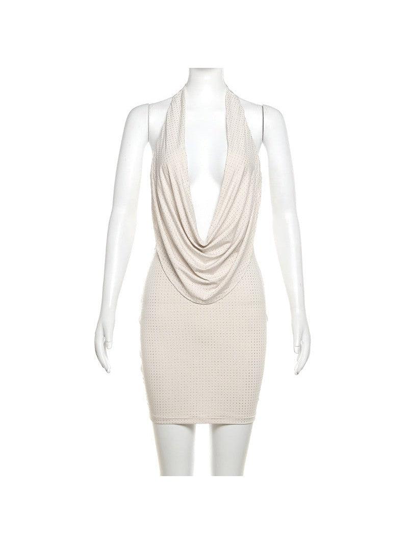 Beige halter-neck backless sheath dress with a draped front neckline and dotted perforated texture.