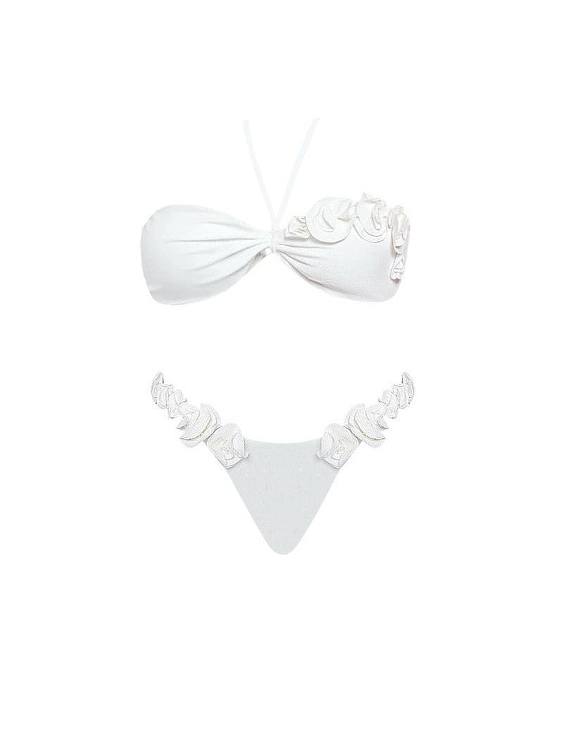 White halter bikini with ruched knot top and floral appliqué rosettes, triangle bottom with floral side accents.
