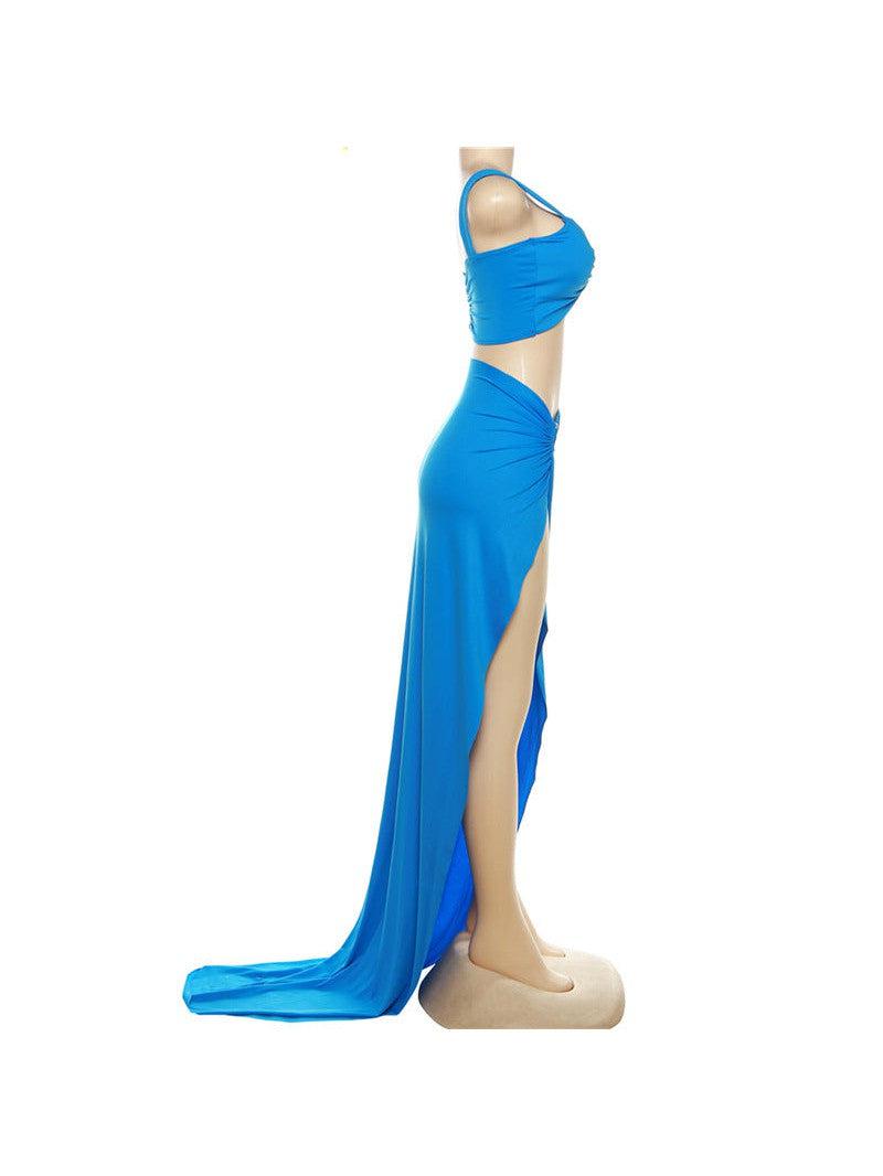 Blue cutout cropped tank top with ruching, paired with a high-waisted floor-length skirt with a side slit, on a mannequin.