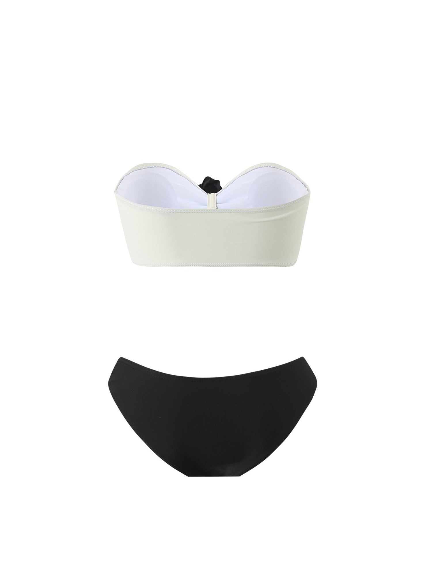 Off-white strapless bandeau bikini top with a small black bow at center, paired with a curved black bikini bottom.