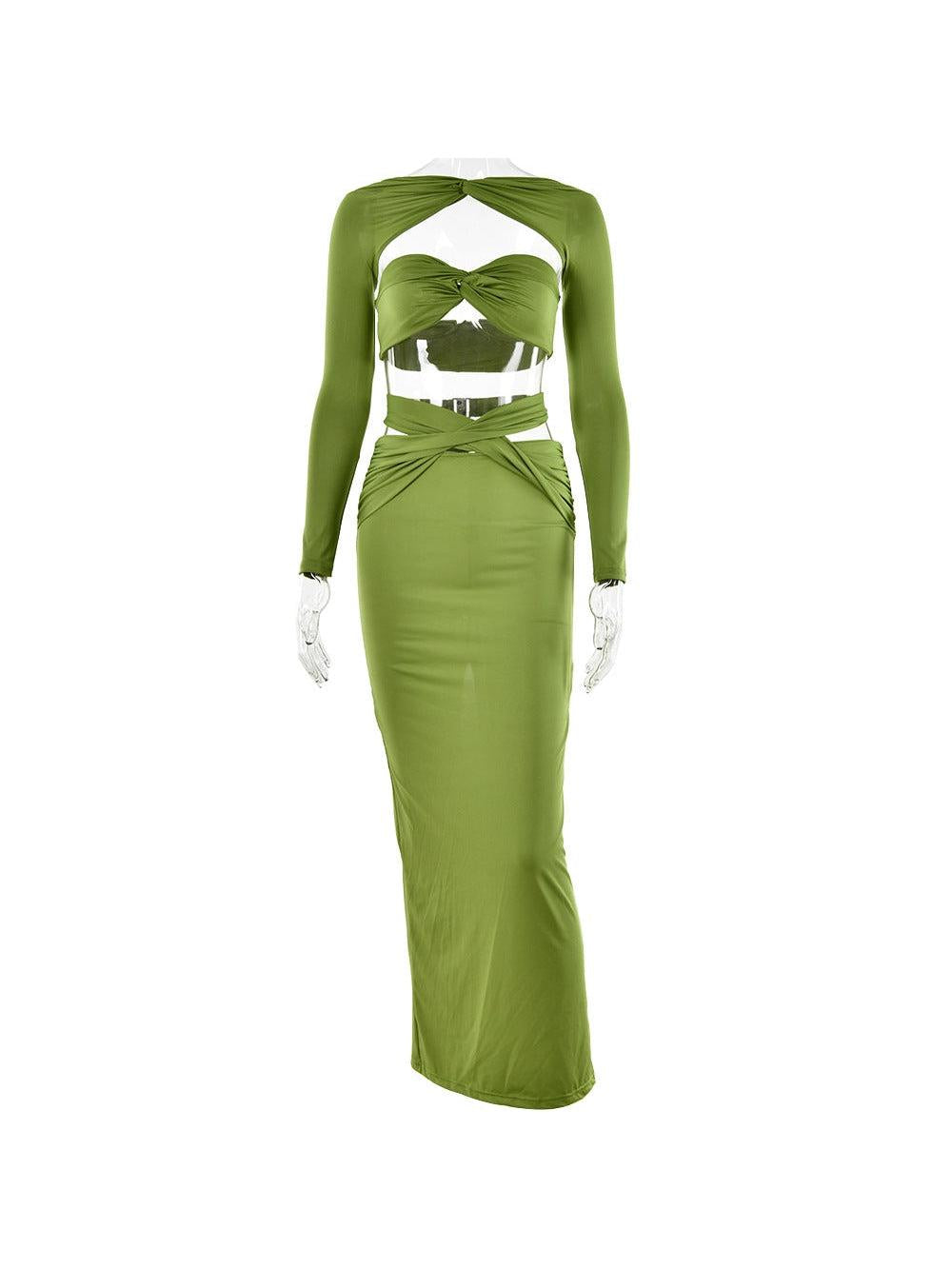 Olive green satin bandeau top with center knot, sheer long sleeves, and a high-waisted twisted-detail maxi skirt.