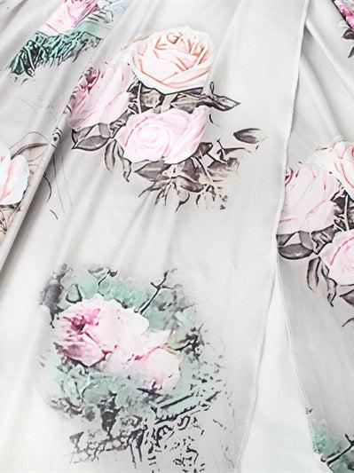 Gray fabric with pink rose and green leaf floral print; pleated skirt from a coordinated set.