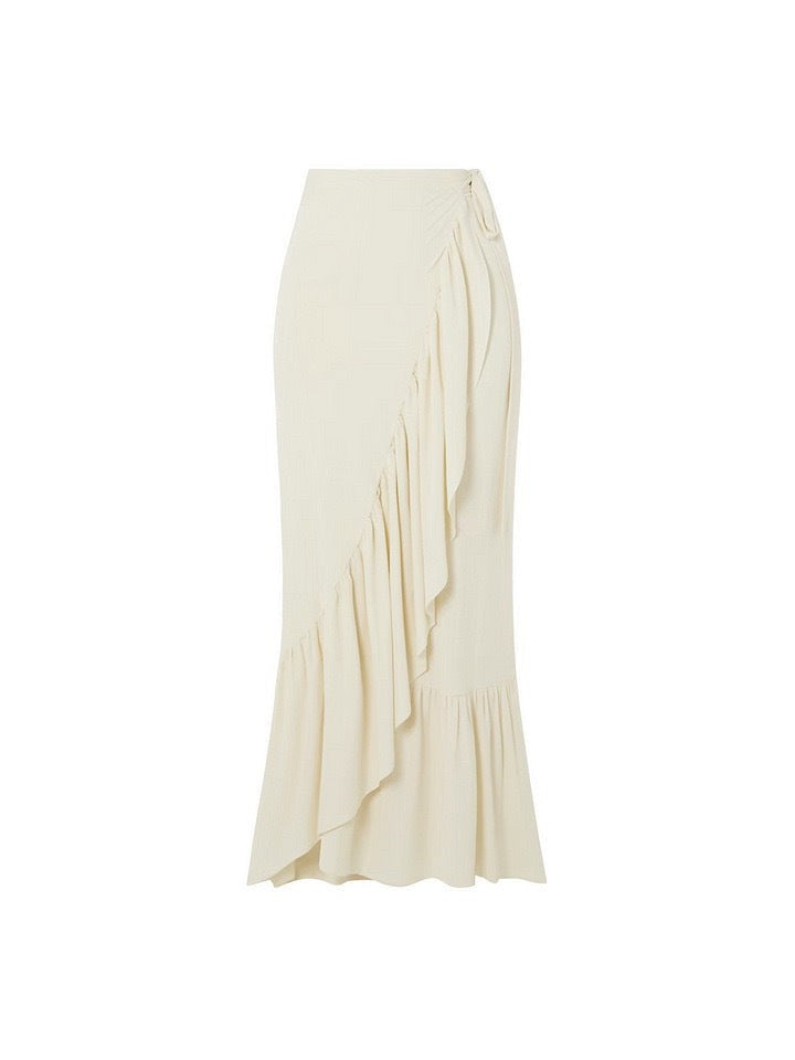 Ivory maxi skirt with an asymmetric wrap drape and cascading ruffle hem.