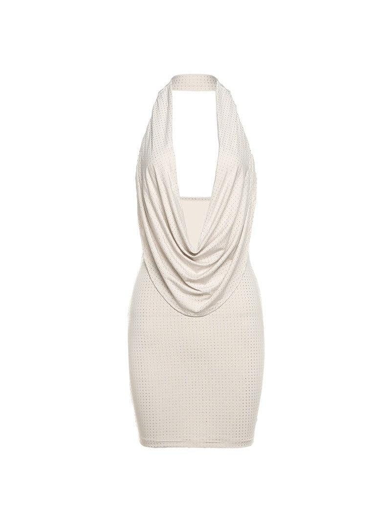 Beige halter-neck backless sheath dress with a draped cowl neckline and dotted texture.