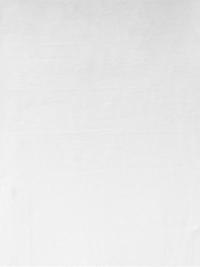 White textured fabric backdrop with subtle wrinkles and soft shadows.