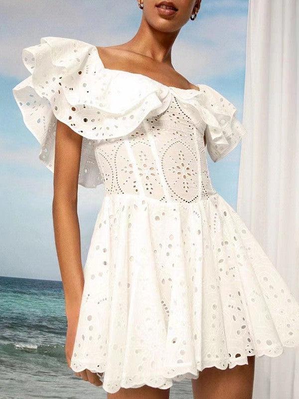 White off-shoulder cotton dress with large puff sleeves and eyelet embroidery, short A-line skirt, beach backdrop.